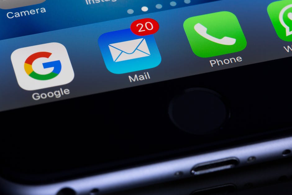 A close-up photo of a smartphone displaying popular apps like Google and Mail